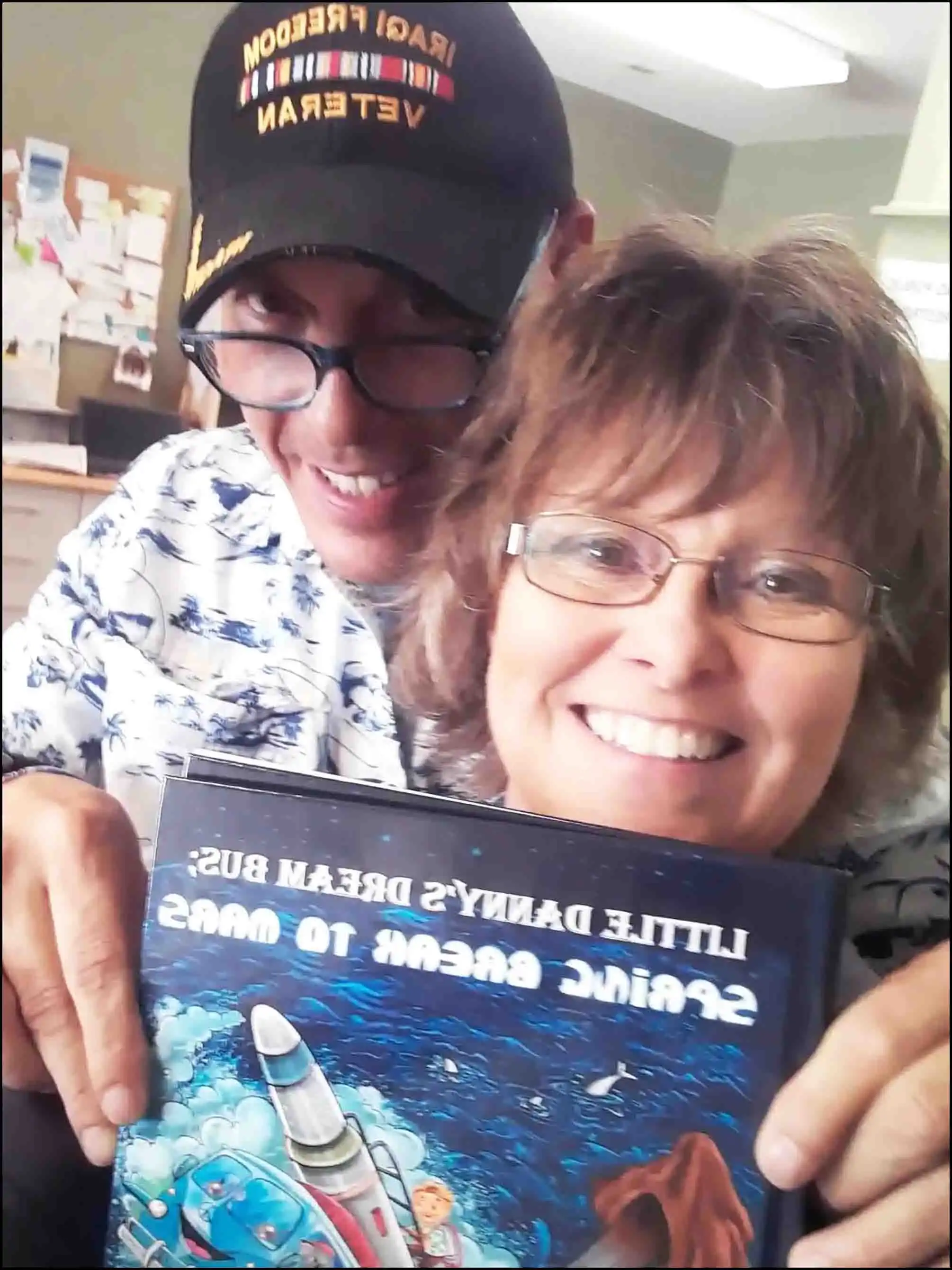 Sharing love and his new book with the DMV staff, Veteran David Haave signs books for employees children and grandchildren -- David Haave